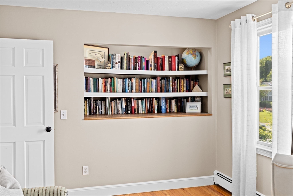 5 Cliff Estates Road Scituate, MA 02066 - Photo 19 of 42 a view of a book shelf with wooden floor in a room