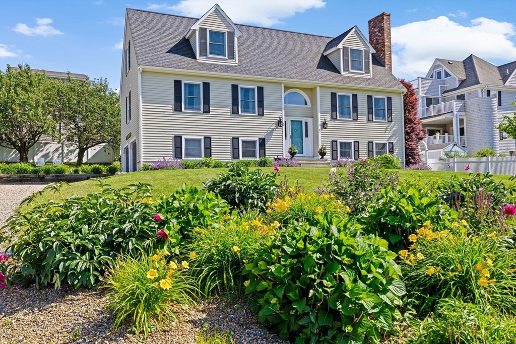 5 Cliff Estates Road Scituate, MA 02066 - Photo 2 of 42 a front view of a house with a garden