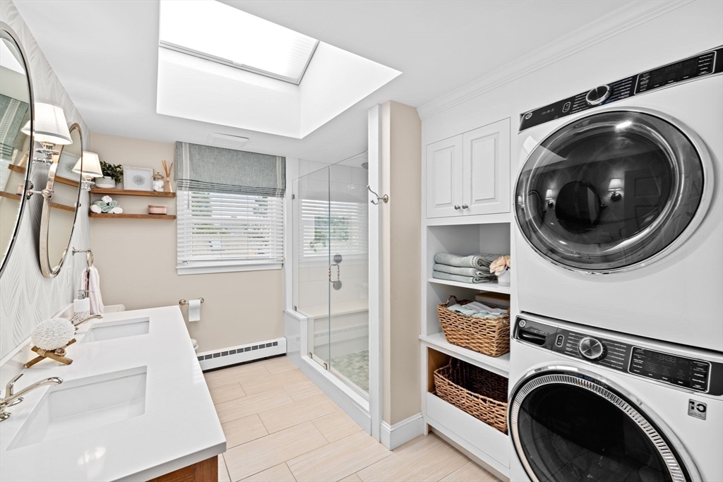 5 Cliff Estates Road Scituate, MA 02066 - Photo 26 of 42 a view of a storage and utility room with washer and dryer