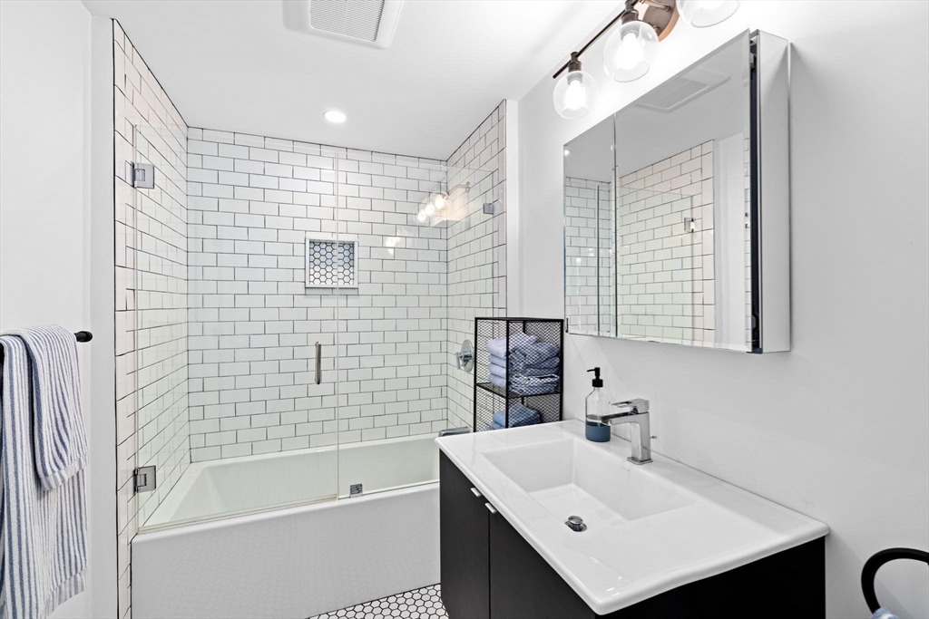 5 Cliff Estates Road Scituate, MA 02066 - Photo 29 of 42 a bathroom with a sink mirror and a bathtub
