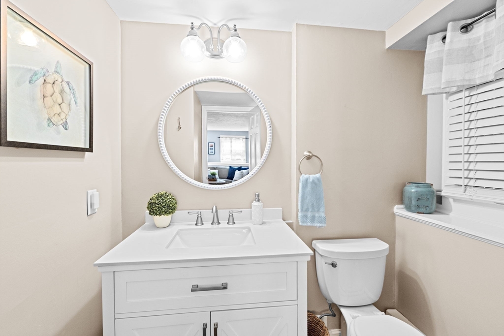 5 Cliff Estates Road Scituate, MA 02066 - Photo 33 of 42 a bathroom with a toilet a sink and a mirror