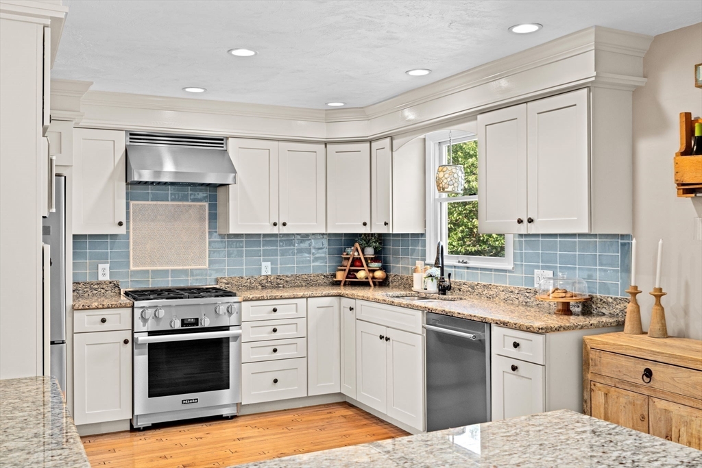 5 Cliff Estates Road Scituate, MA 02066 - Photo 5 of 42 a kitchen with a white stove top oven and cabinets