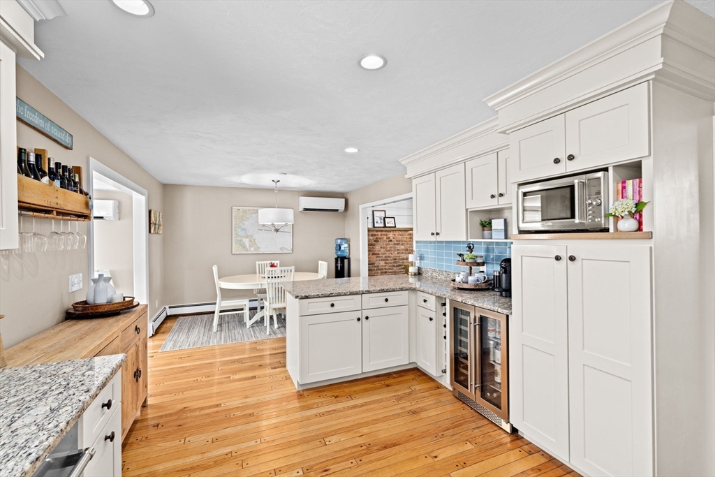 5 Cliff Estates Road Scituate, MA 02066 - Photo 9 of 42 a kitchen with white cabinets and appliances