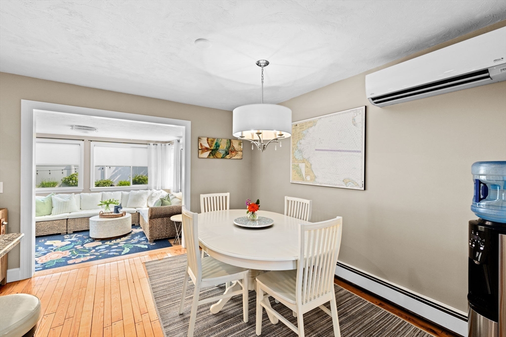 5 Cliff Estates Road Scituate, MA 02066 - Photo 10 of 42 a dining room with furniture a chandelier and wooden floor