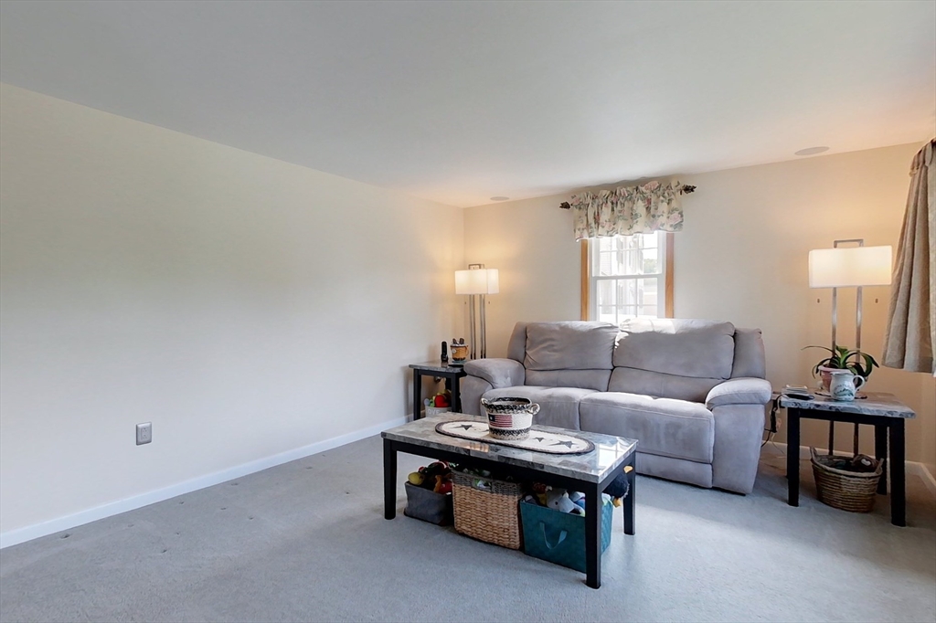 103 Lowell Road Pepperell, MA 01463 - Photo 12 of 42 a living room with furniture and lamp