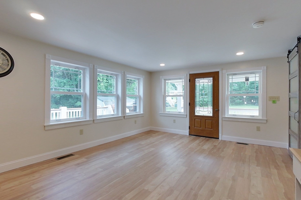 103 Lowell Road Pepperell, MA 01463 - Photo 18 of 42 a view of an empty room with a window and wooden floor