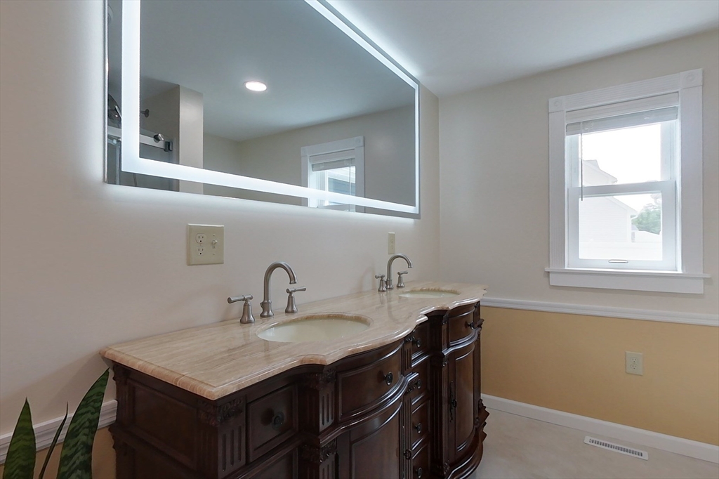 103 Lowell Road Pepperell, MA 01463 - Photo 20 of 42 a bathroom with a sink and a window