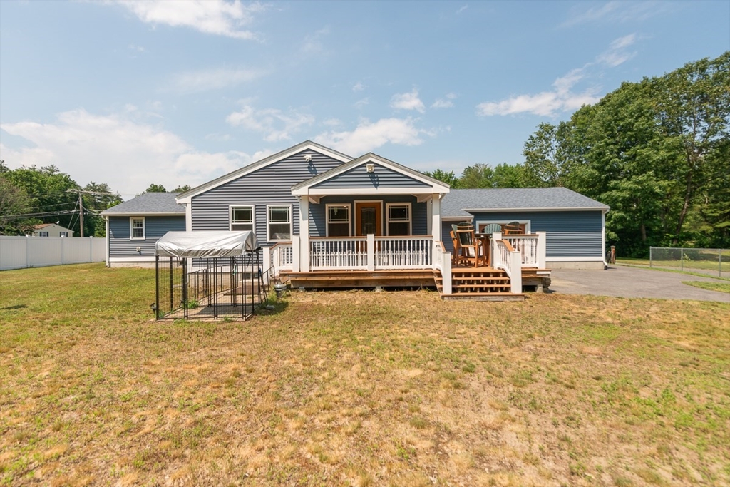 103 Lowell Road Pepperell, MA 01463 - Photo 2 of 42 a white house that has a table and chairs in it
