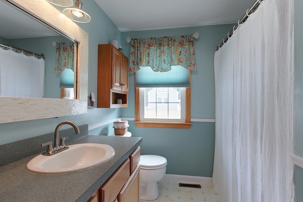 103 Lowell Road Pepperell, MA 01463 - Photo 31 of 42 a bathroom with a toilet sink and mirror