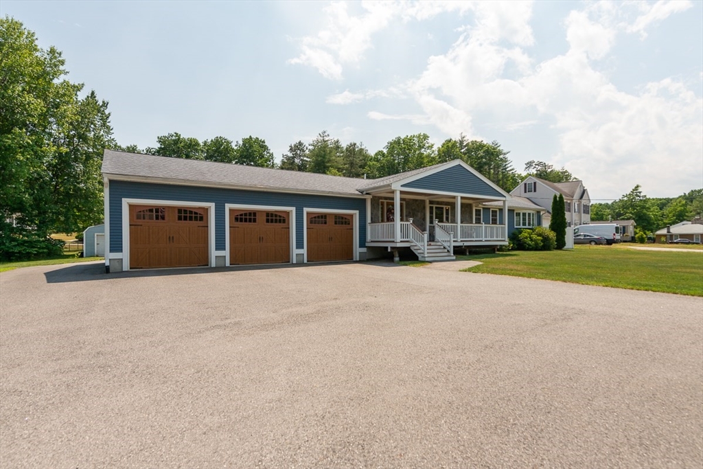 103 Lowell Road Pepperell, MA 01463 - Photo 32 of 42 front view of a house with a yard