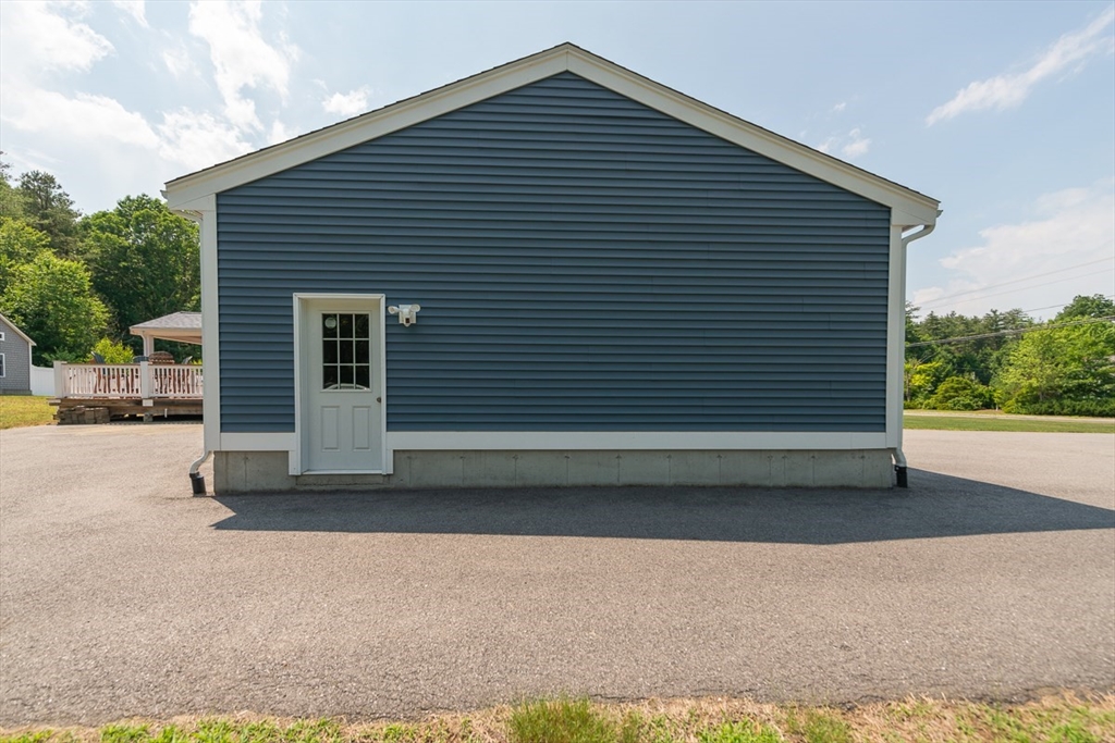 103 Lowell Road Pepperell, MA 01463 - Photo 33 of 42 a front view of a house with a garage