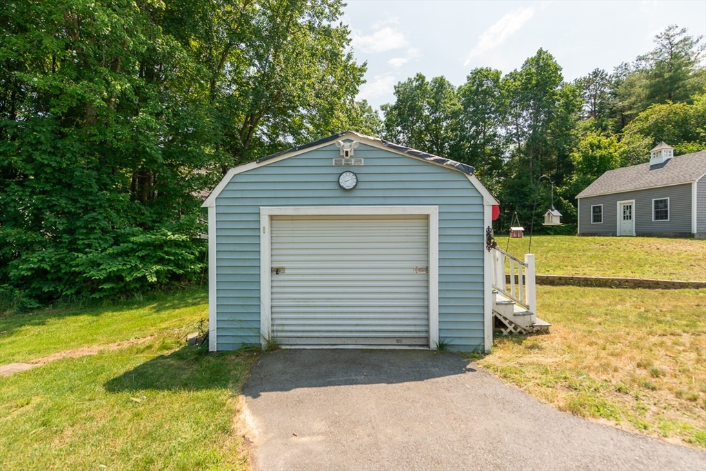 103 Lowell Road Pepperell, MA 01463 - Photo 39 of 42 a front view of a house with a yard