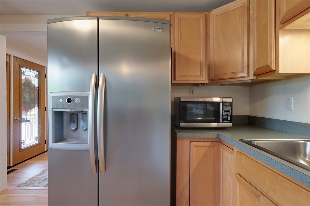 103 Lowell Road Pepperell, MA 01463 - Photo 5 of 42 a kitchen with stainless steel appliances granite countertop a refrigerator a microwave and sink