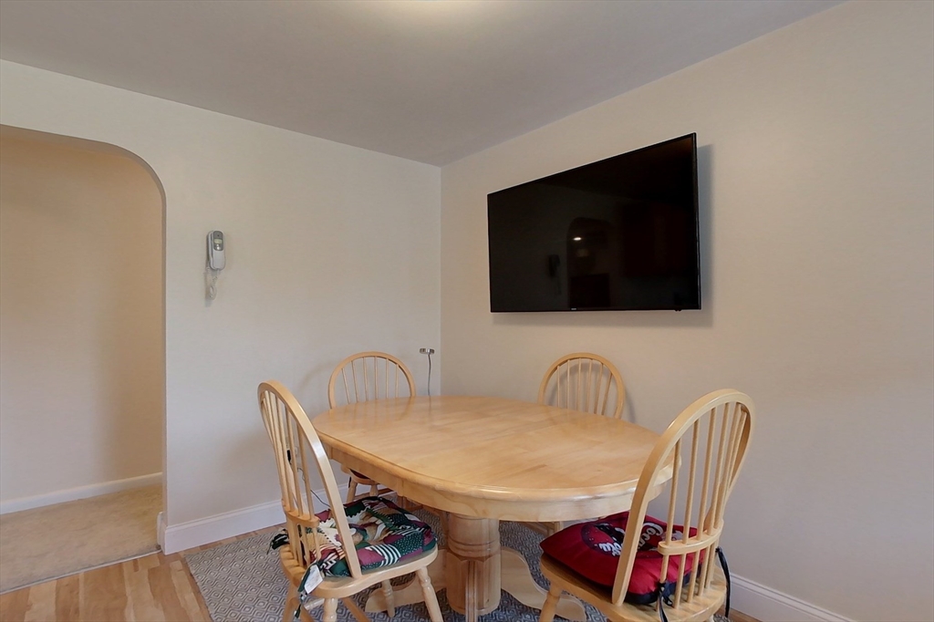 103 Lowell Road Pepperell, MA 01463 - Photo 7 of 42 a view of a dining room with furniture and wooden floor