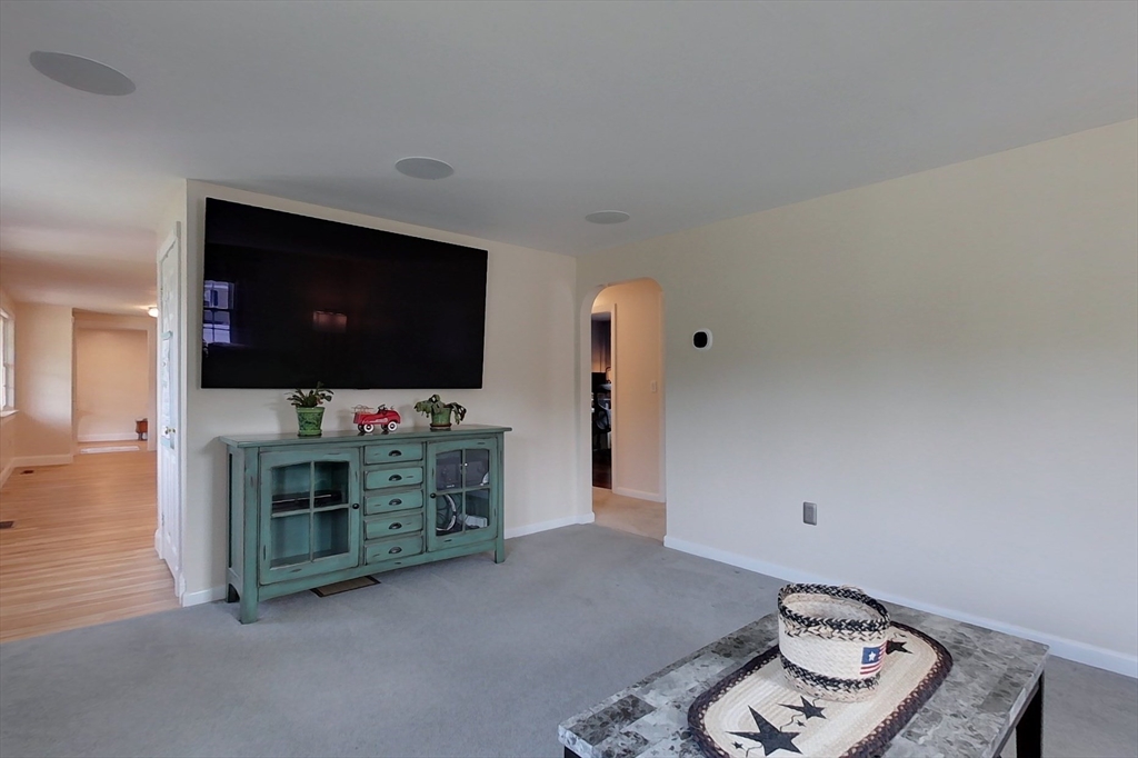 103 Lowell Road Pepperell, MA 01463 - Photo 9 of 42 a living room with furniture and a flat screen tv