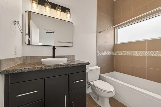 a bathroom with a granite countertop sink a mirror and a