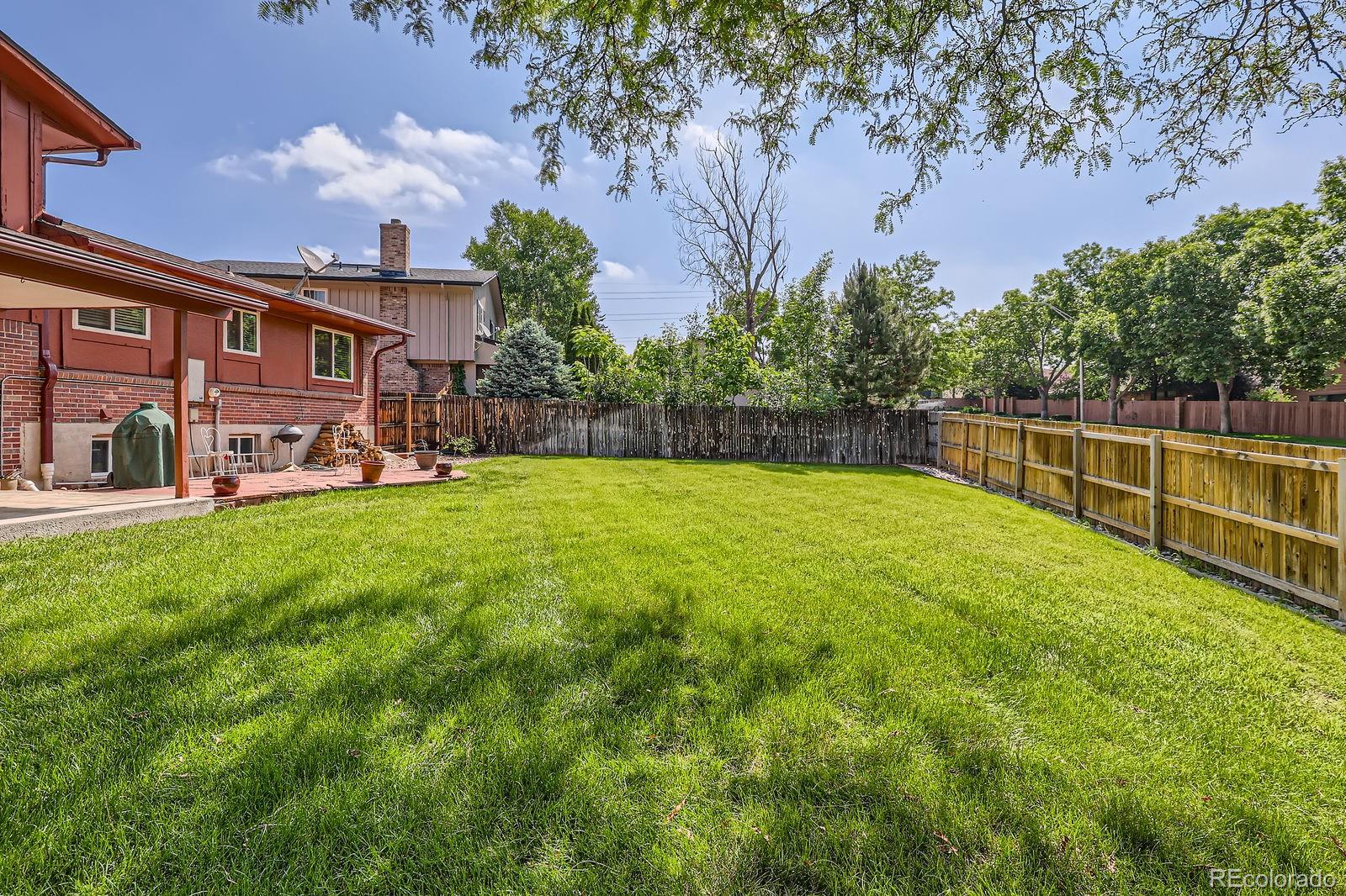 7464 East Colgate Place Denver, CO 80231 - Photo 6 of 7 a view of a house with a yard porch and sitting area