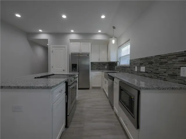 a view of kitchen with a sink wooden floor and kitchen