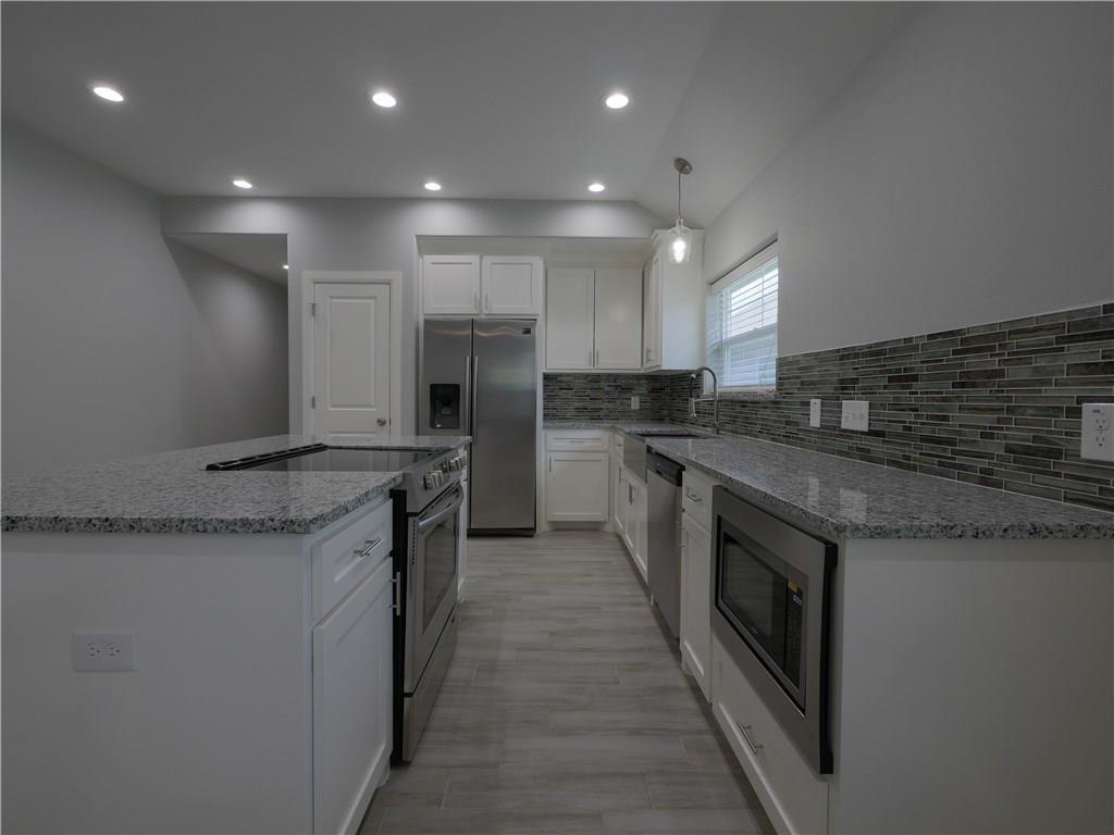 605 East Carter Street Sherman, TX 75090 - Photo 2 of 10 a kitchen with stainless steel appliances granite countertop a sink and a stove