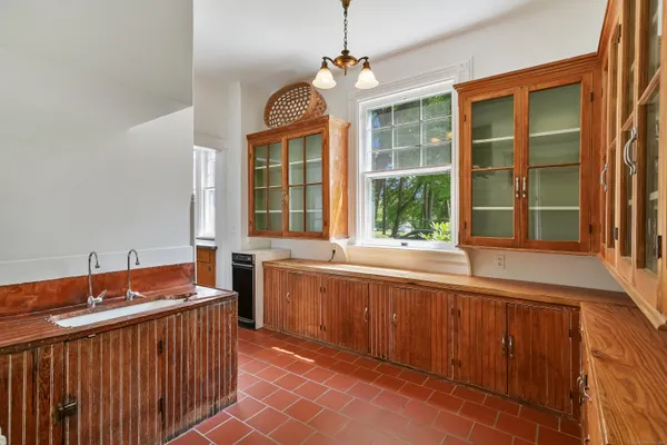 a large kitchen with kitchen island granite countertop a sink and a large window