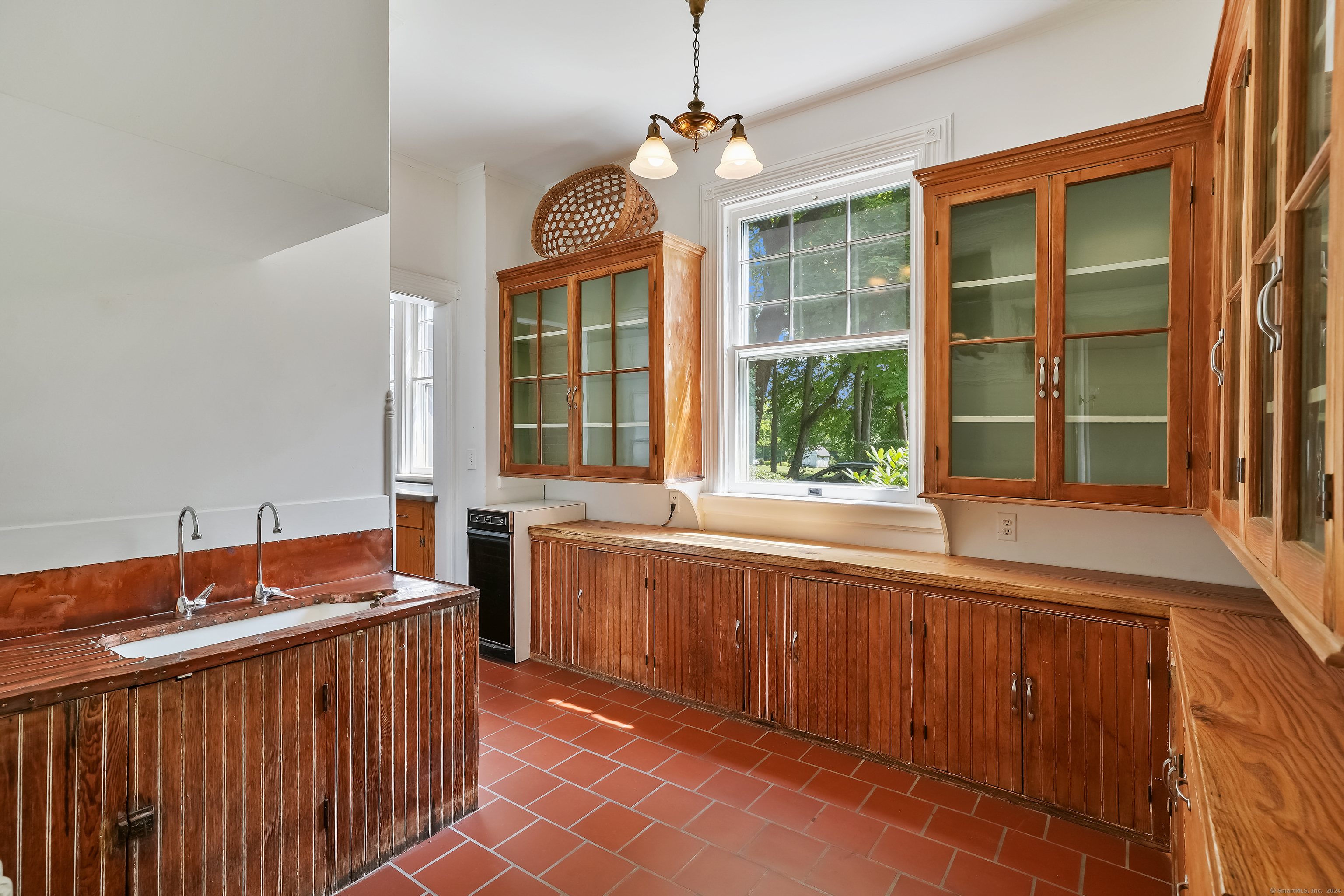 56 East Ridge Road Ridgefield, CT 06877 - Photo 14 of 38 a large kitchen with kitchen island granite countertop a sink and a large window