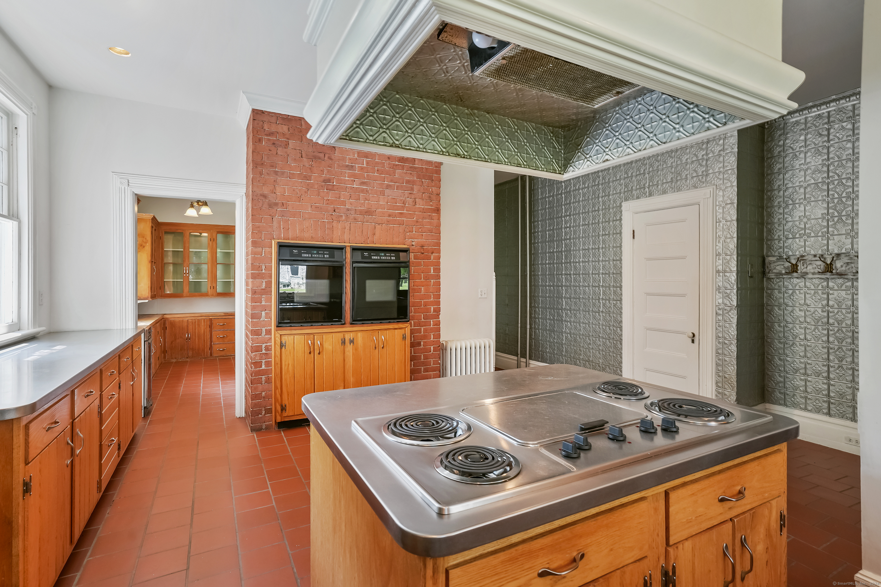 56 East Ridge Road Ridgefield, CT 06877 - Photo 17 of 38 a kitchen with a stove and a refrigerator
