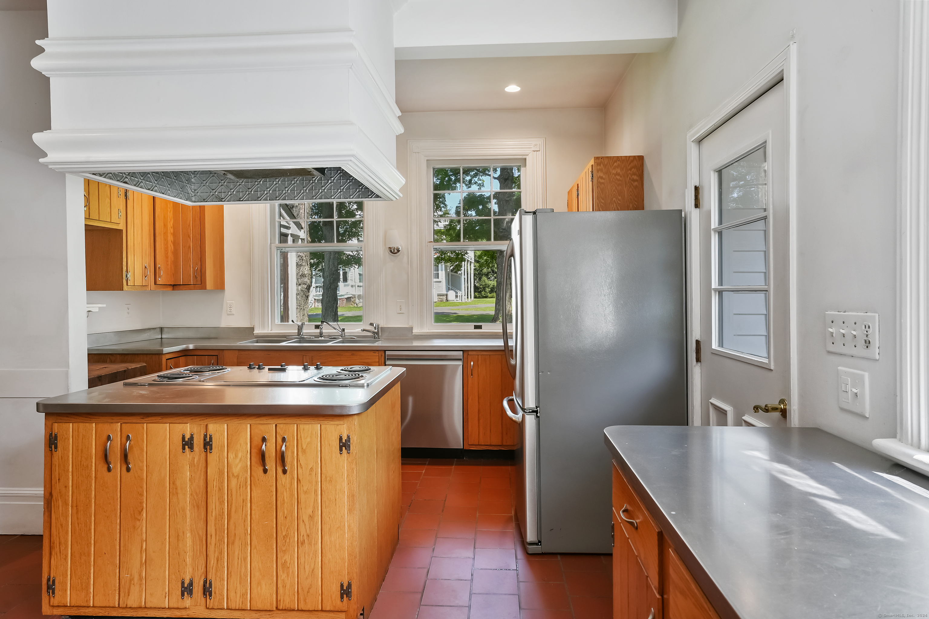 56 East Ridge Road Ridgefield, CT 06877 - Photo 18 of 38 a kitchen with stainless steel appliances granite countertop a refrigerator and a sink