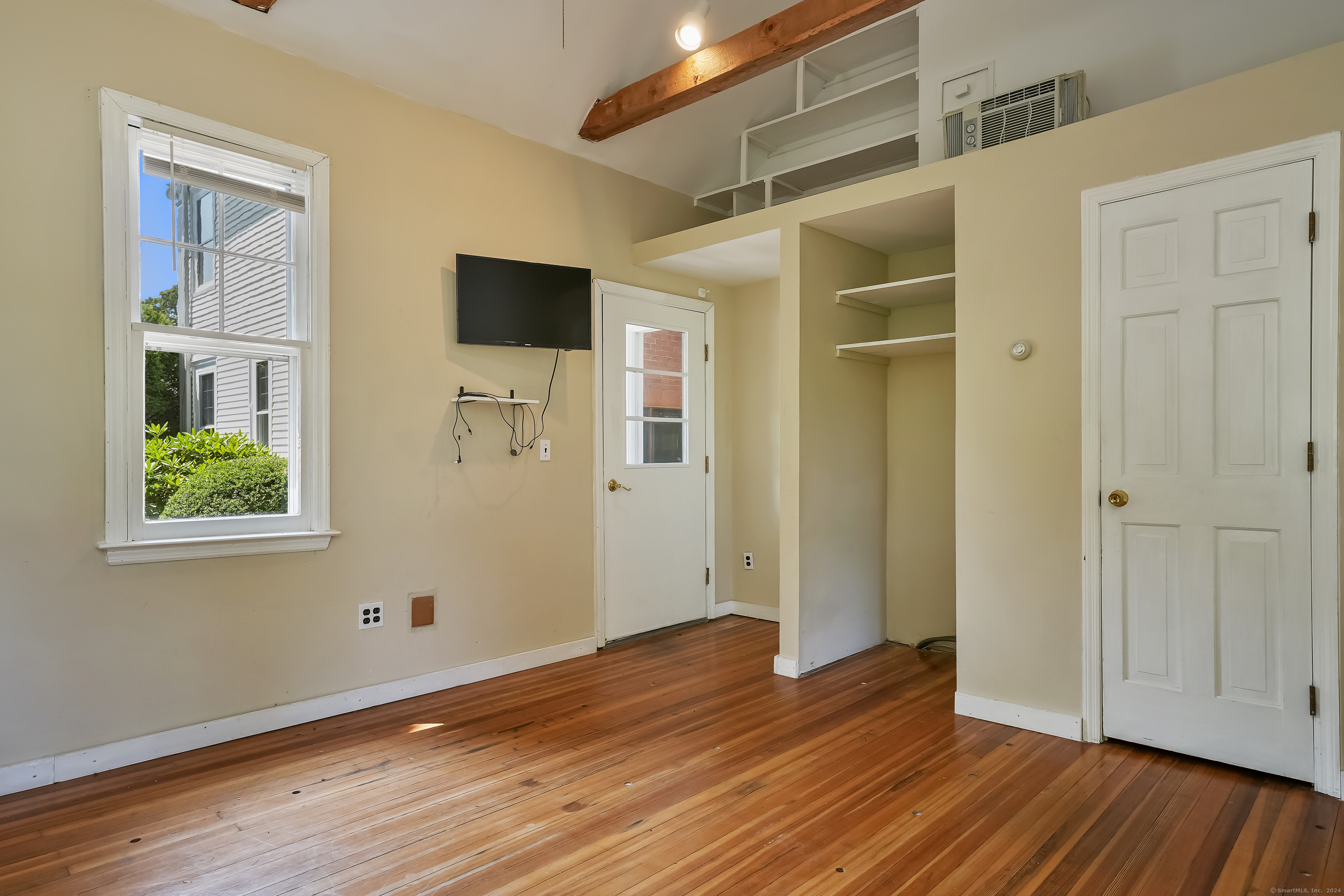 56 East Ridge Road Ridgefield, CT 06877 - Photo 19 of 38 an empty room with wooden floor and windows