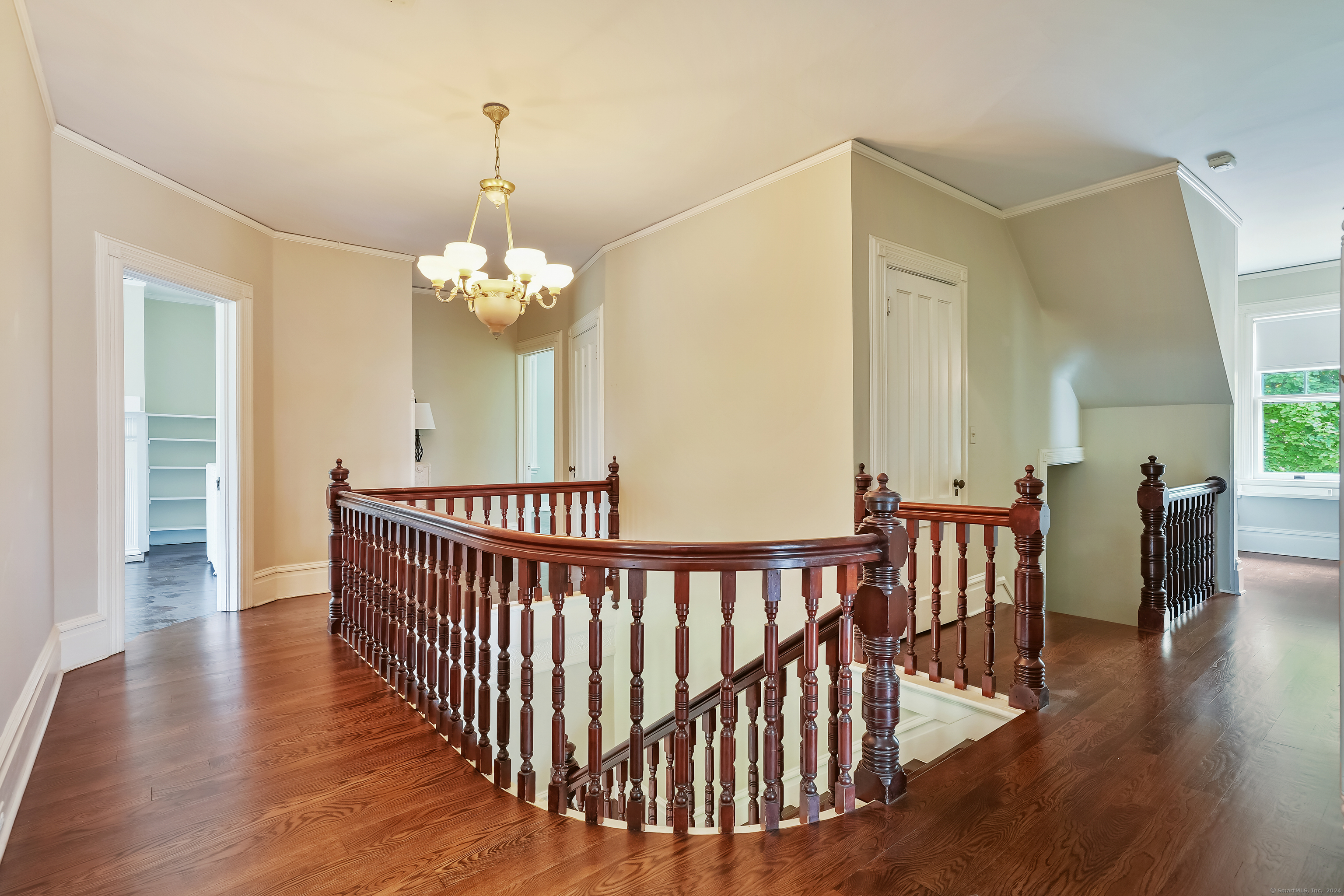 56 East Ridge Road Ridgefield, CT 06877 - Photo 20 of 38 a view of a dining room with wooden floor windows and a chandelier