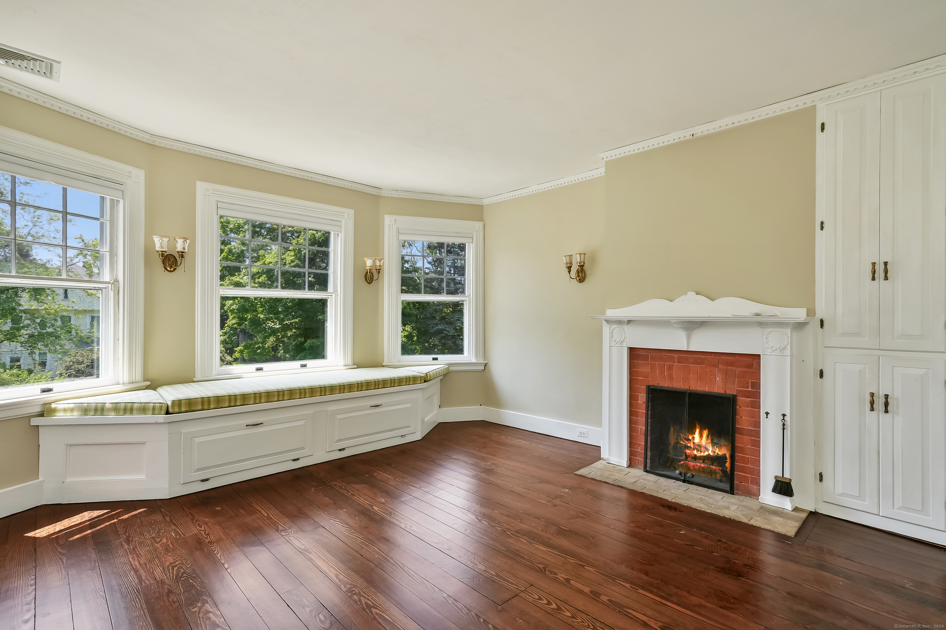 56 East Ridge Road Ridgefield, CT 06877 - Photo 24 of 38 a living room with a fireplace with wooden floor