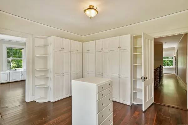 a view of a room with wooden floor and cabinet