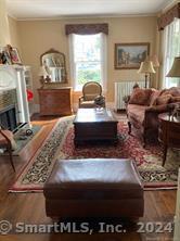 56 East Ridge Road Ridgefield, CT 06877 - Photo 30 of 38 a living room with furniture a window and a fireplace