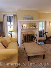 56 East Ridge Road Ridgefield, CT 06877 - Photo 31 of 38 a living room with furniture and a fireplace