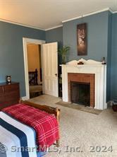 56 East Ridge Road Ridgefield, CT 06877 - Photo 34 of 38 a bedroom with a bed and a fireplace