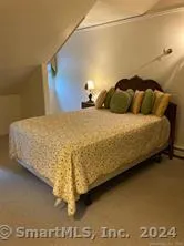 a bed sitting in a bedroom next to a wall