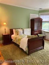 a bed sitting in a room next to a window