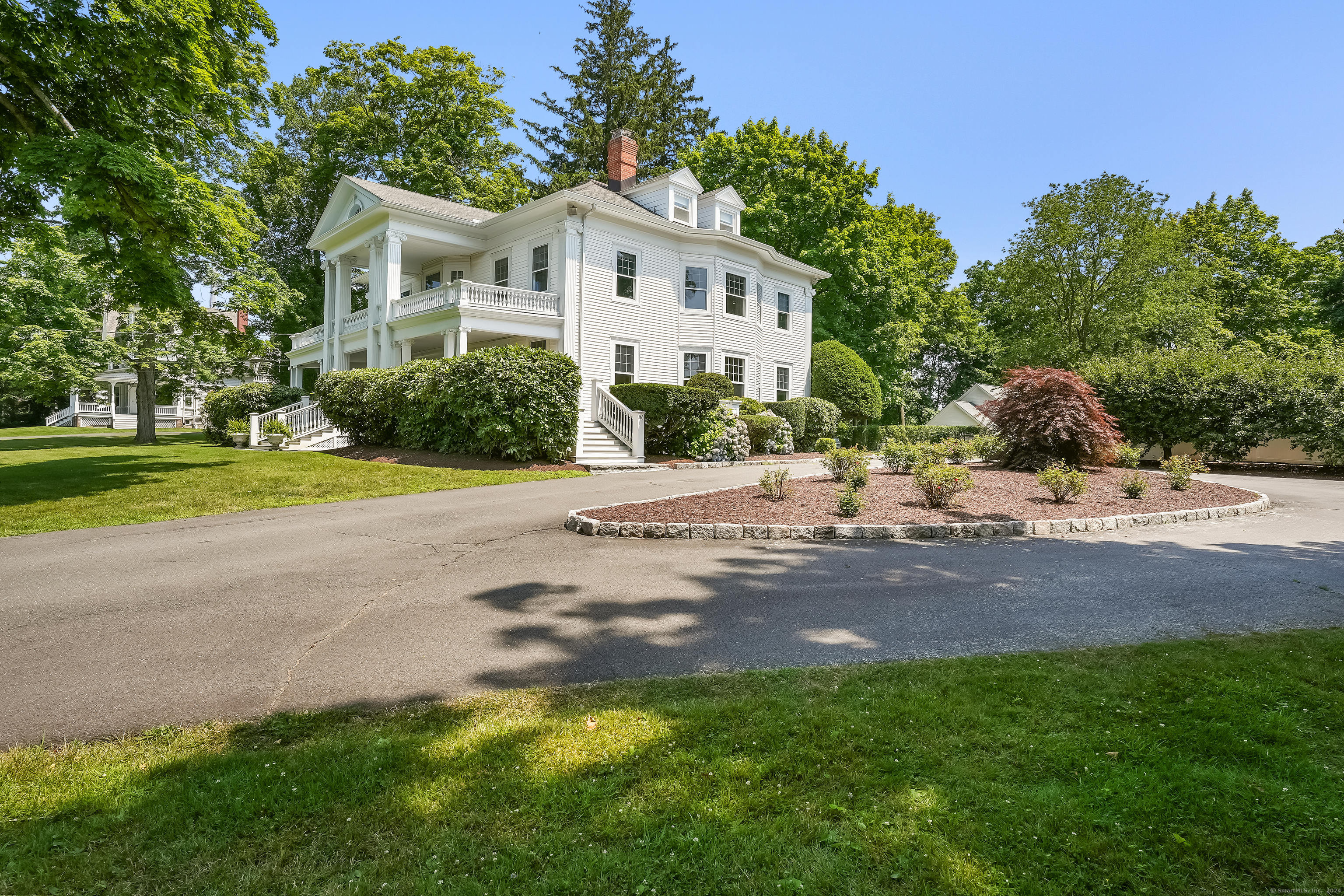 56 East Ridge Road Ridgefield, CT 06877 - Photo 4 of 38 a front view of a house with a yard and garage