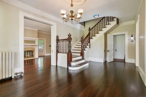 a view of entryway and hall with wooden floor