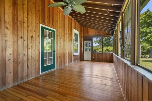 a view of a porch with wooden floor and stairs