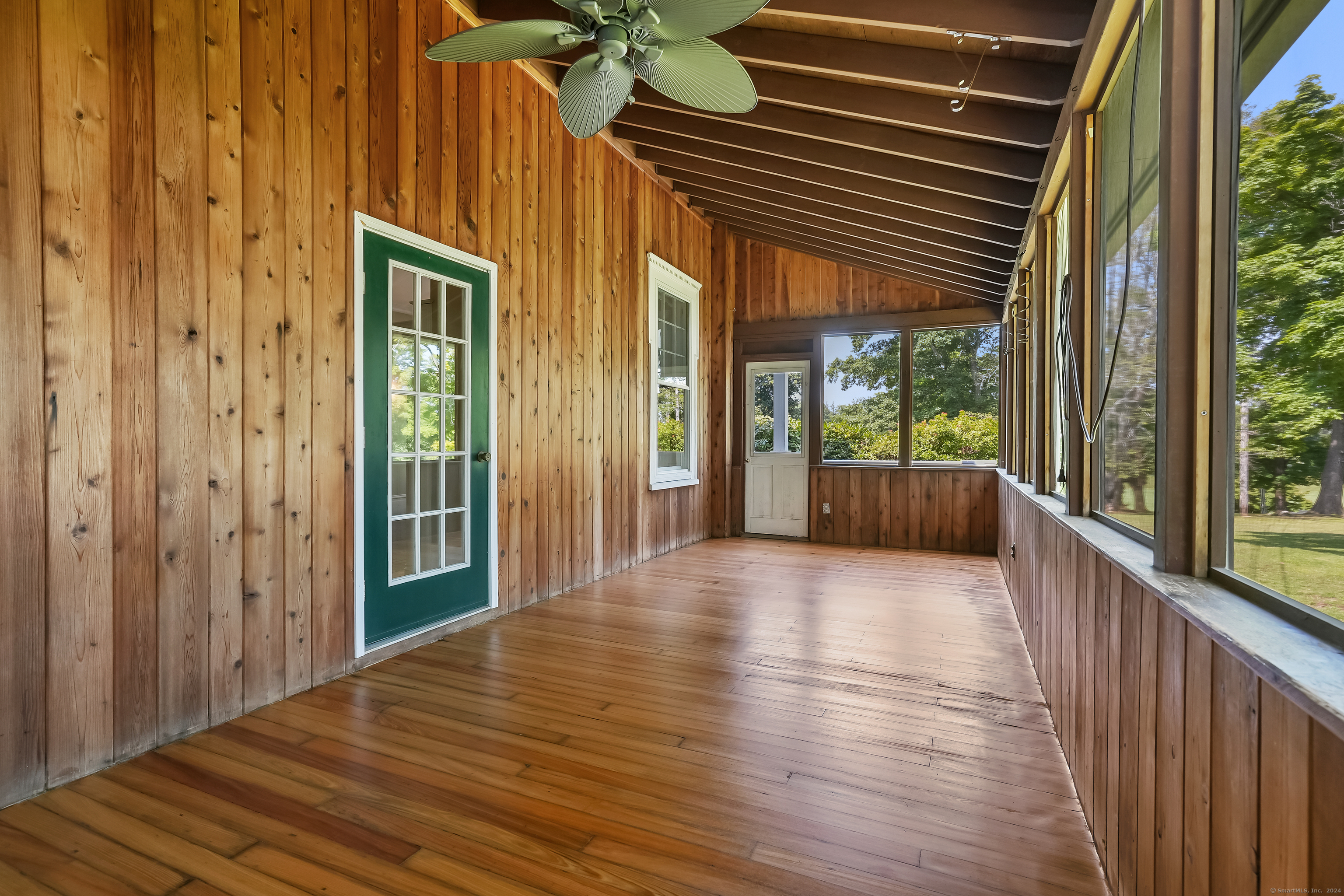 56 East Ridge Road Ridgefield, CT 06877 - Photo 9 of 38 a view of a porch with wooden floor and stairs