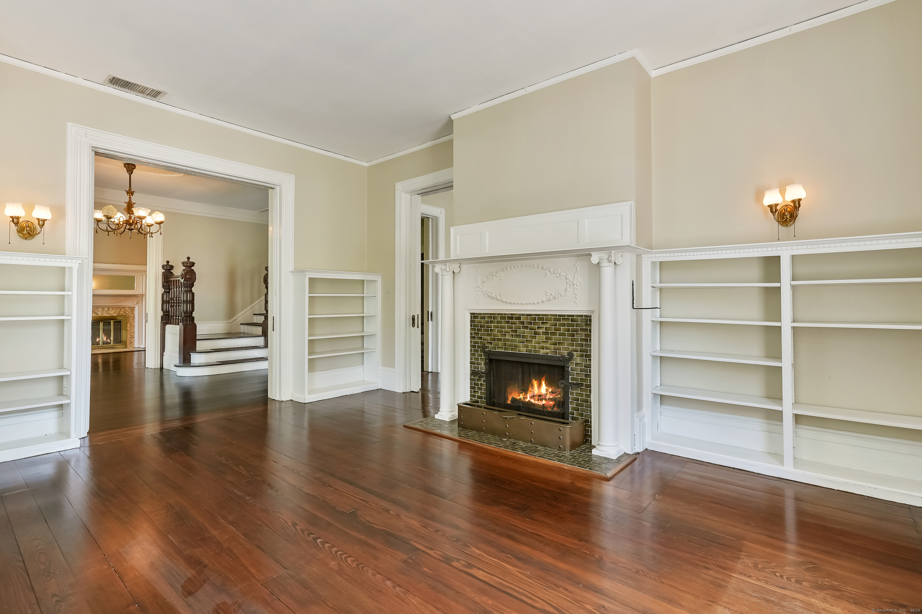 56 East Ridge Road Ridgefield, CT 06877 - Photo 10 of 38 a view of an empty room with wooden floor fire place and fire place