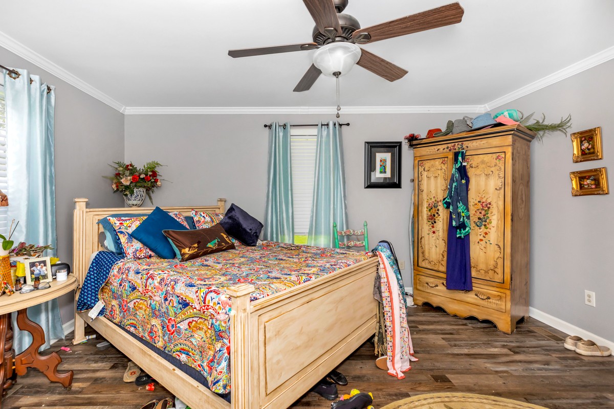 113 Elliot Road Ardmore, TN 38449 - Photo 11 of 25 a bed room with a bed and a chandelier