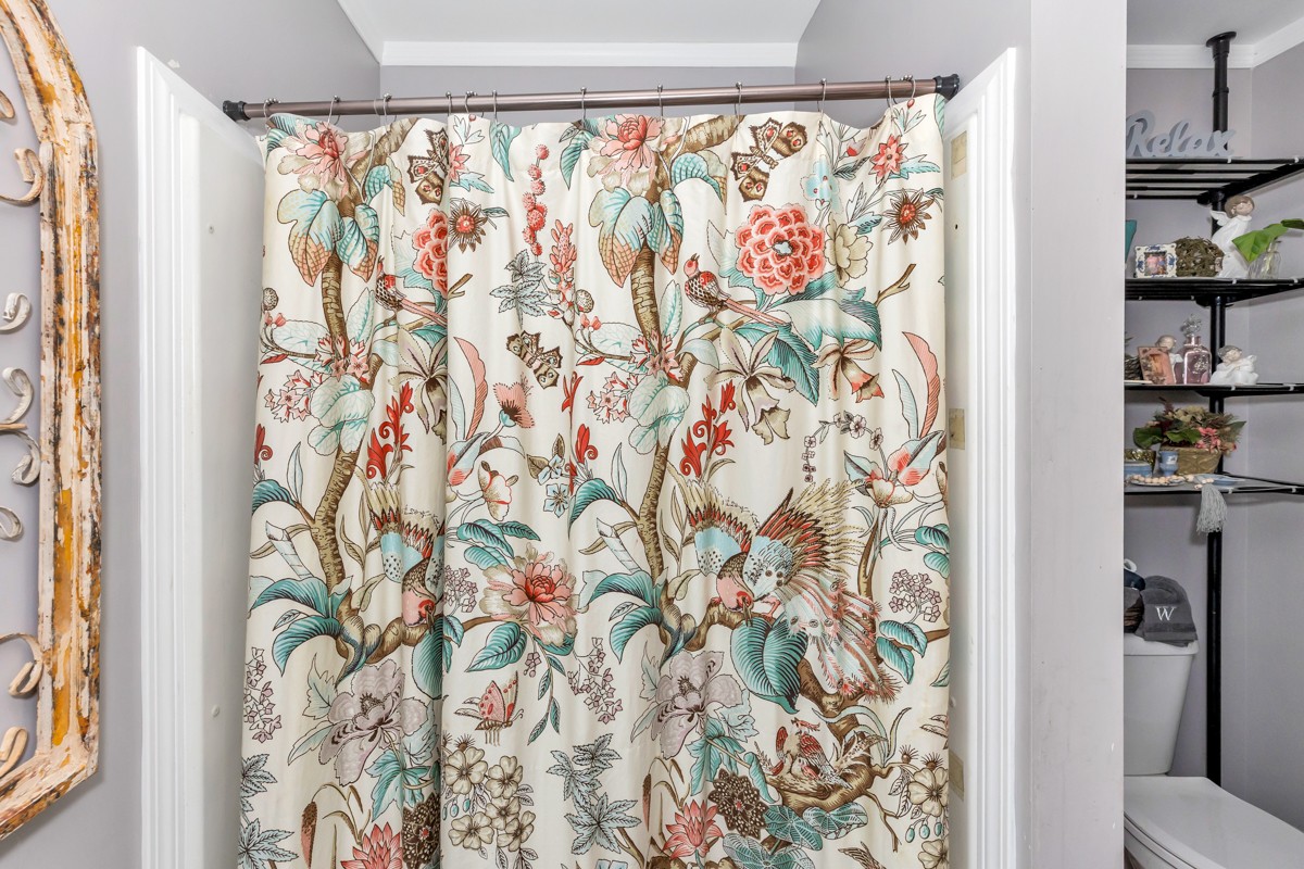 113 Elliot Road Ardmore, TN 38449 - Photo 14 of 25 a bathroom with a shower curtain and a curtain