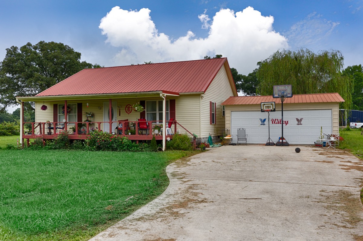 113 Elliot Road Ardmore, TN 38449 - Photo 16 of 25 a front view of a house with a yard and a garage
