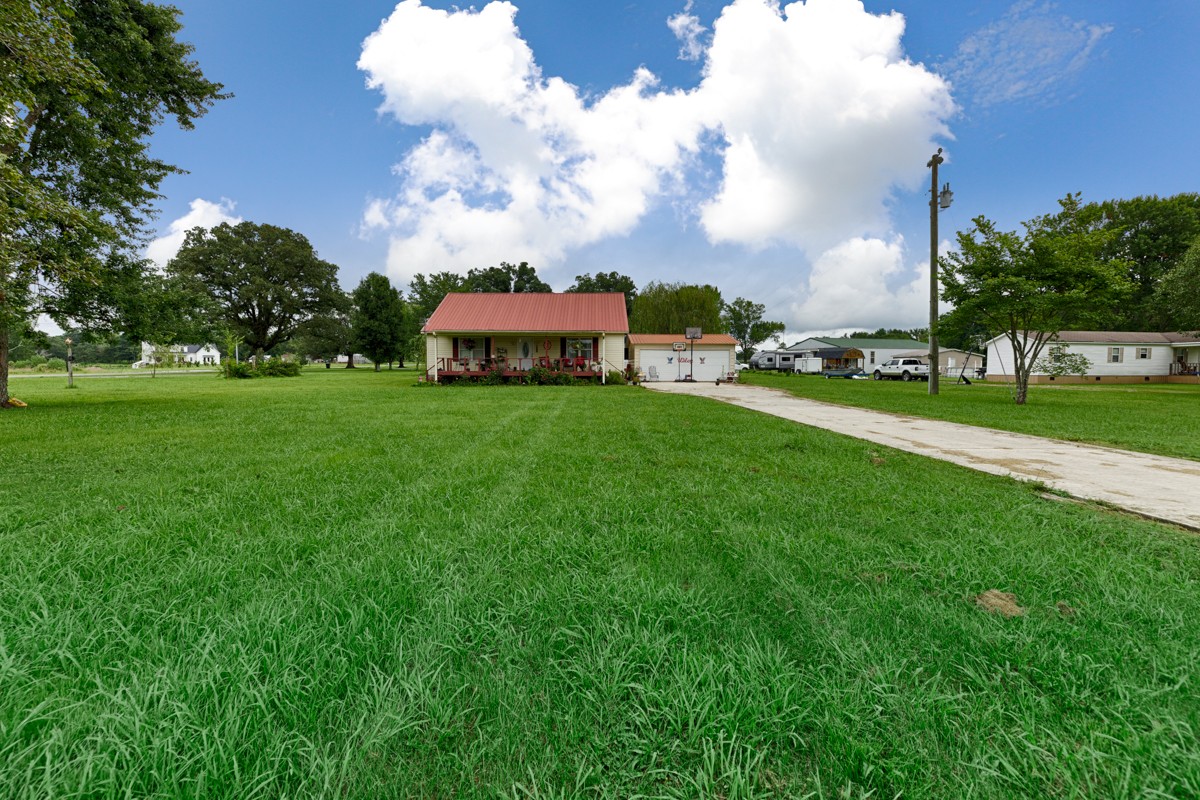 113 Elliot Road Ardmore, TN 38449 - Photo 17 of 25 a view of a fountain in front of a big yard with plants and large trees