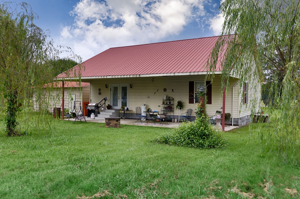 113 Elliot Road Ardmore, TN 38449 - Photo 19 of 25 a front view of a house with patio and garden