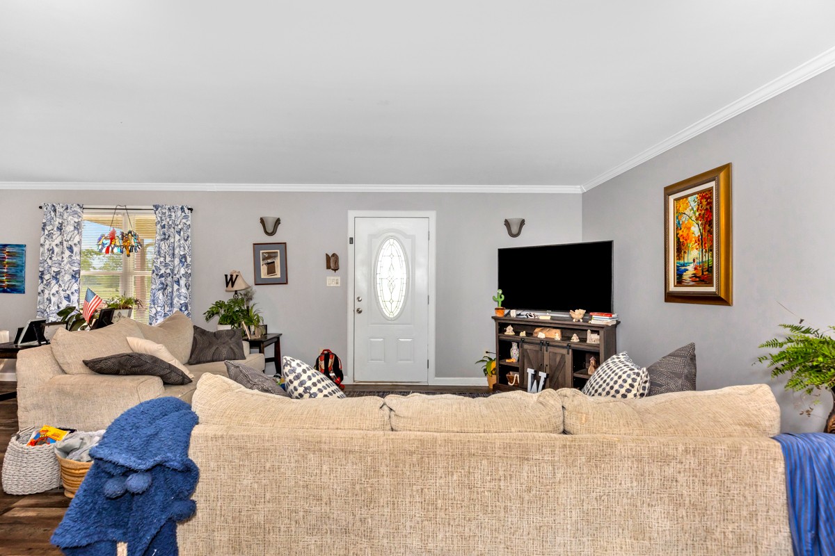 113 Elliot Road Ardmore, TN 38449 - Photo 4 of 25 a bedroom with furniture and a flat screen tv