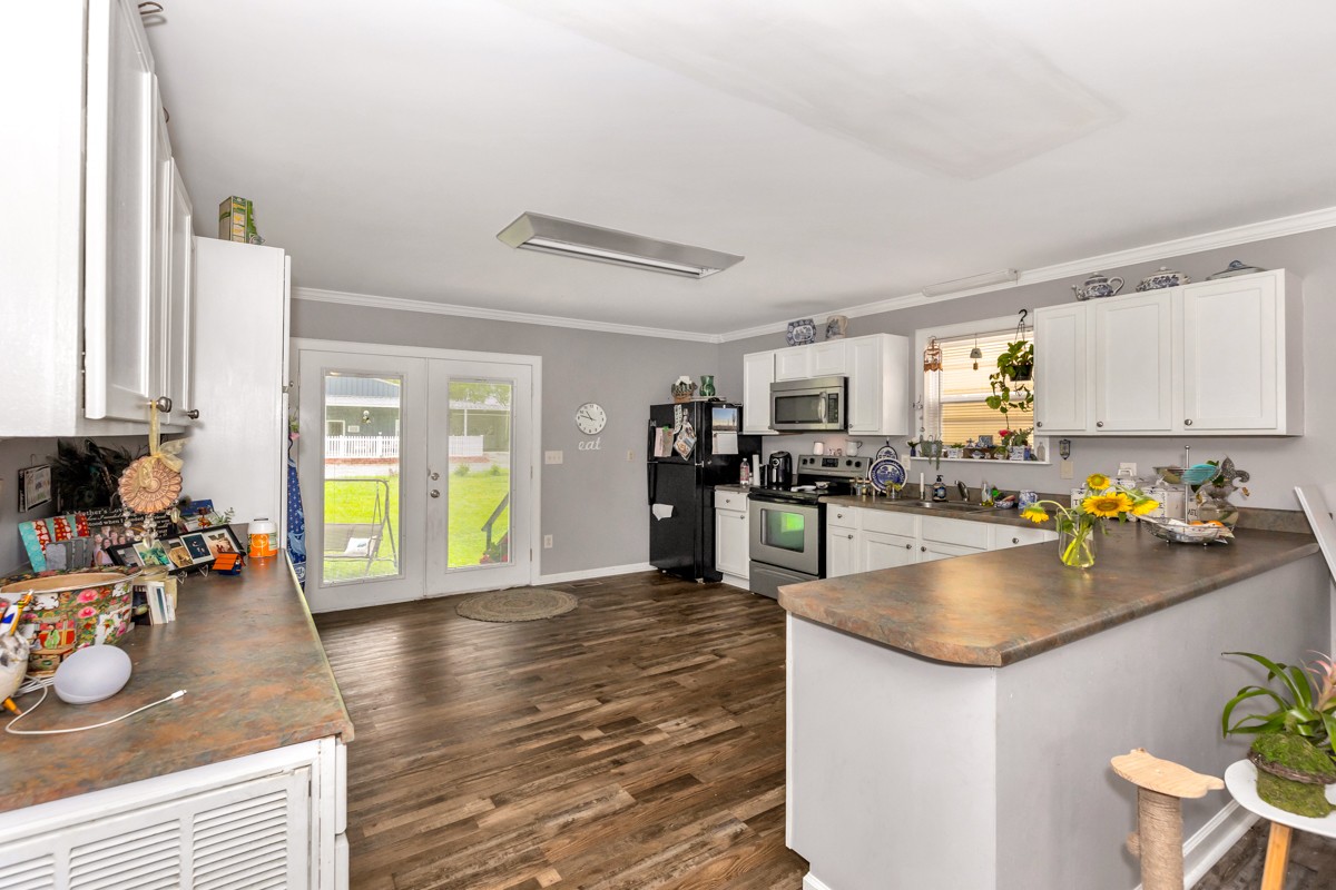 113 Elliot Road Ardmore, TN 38449 - Photo 7 of 25 a view of a kitchen with kitchen island a large counter space and stainless steel appliances