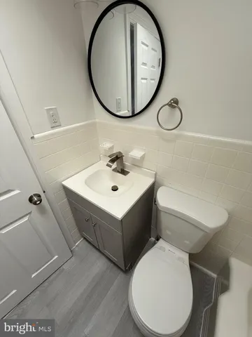 a bathroom with a sink mirror and toilet