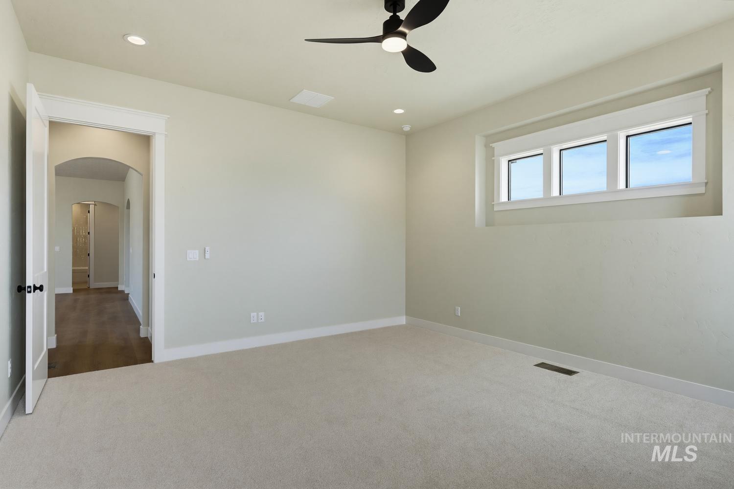 5054 Heritage Drive Marsing, ID 83639 - Photo 31 of 38 Spacious carpeted room featuring a ceiling fan, recessed lighting, and a three-pane window